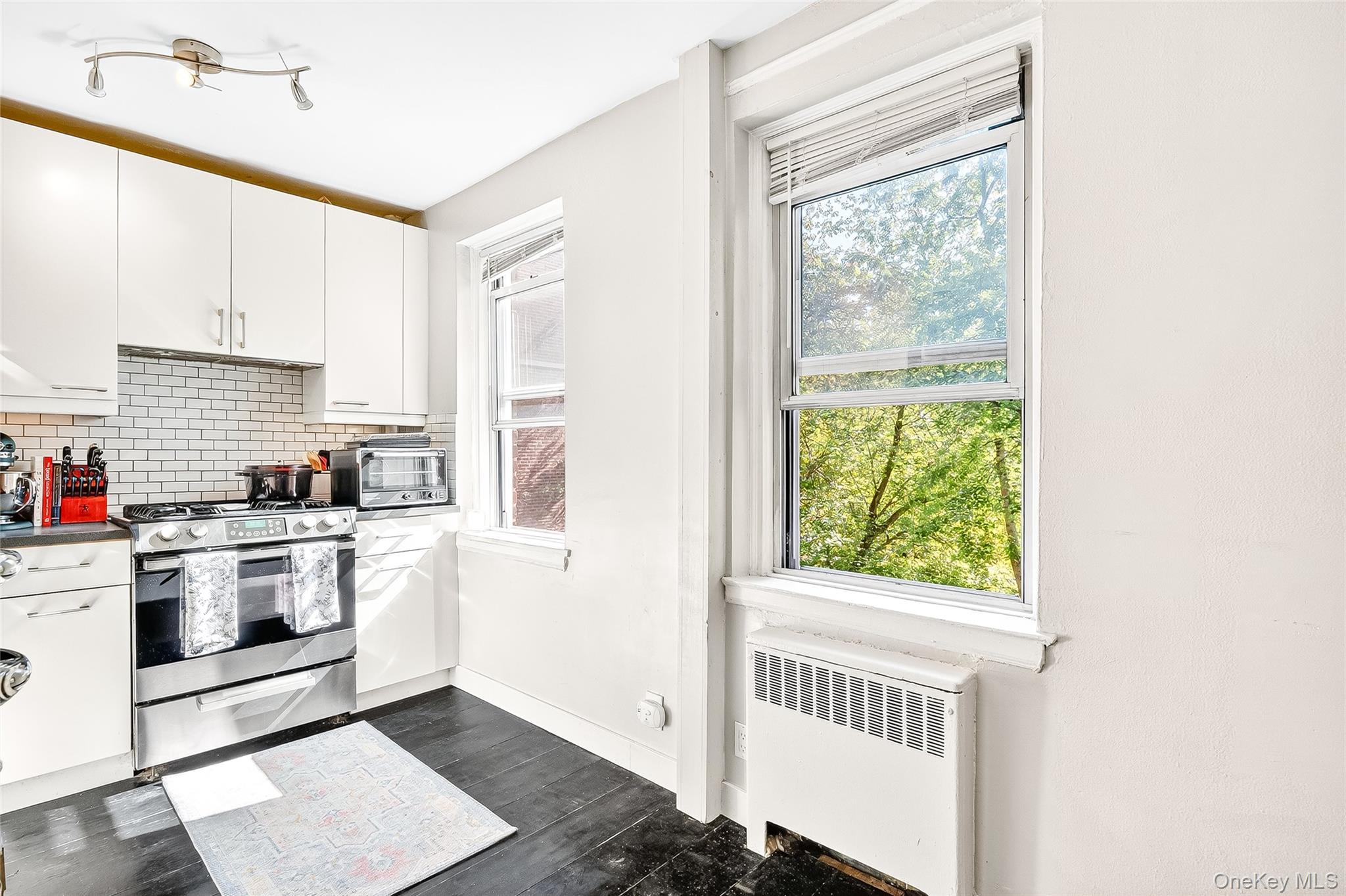 821 Bronx River Road, Unit 5J Bronxville, NY 10708 - Photo 8 of 30 a kitchen with a stove a sink and a window