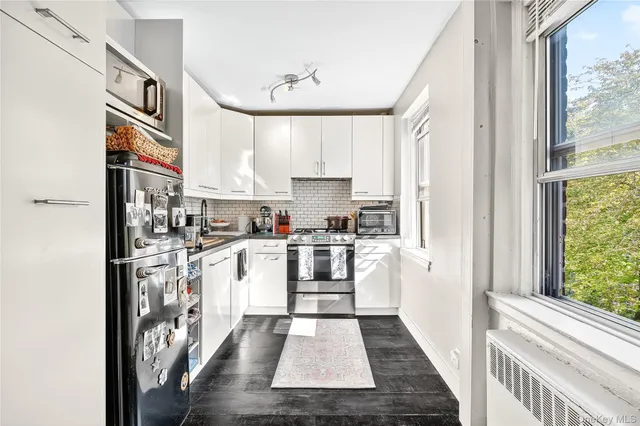 a kitchen with stainless steel appliances granite countertop a refrigerator and a stove