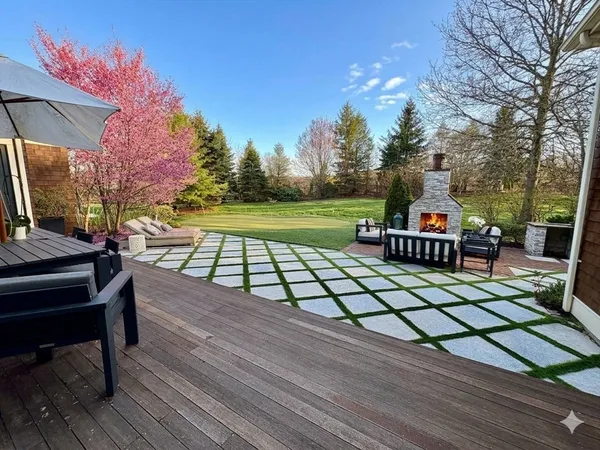 a view of a patio with table and chairs a barbeque with wooden floor and fence