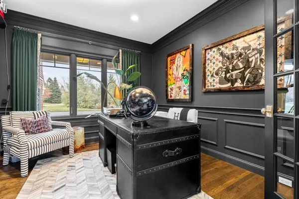 a living room with furniture a large window and a fireplace