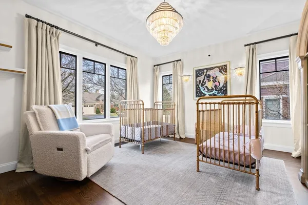 a view of a bedroom with furniture and a large window