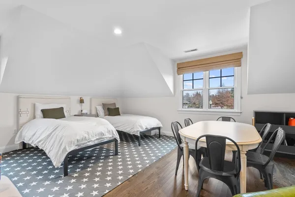 a bedroom with two beds and a large window