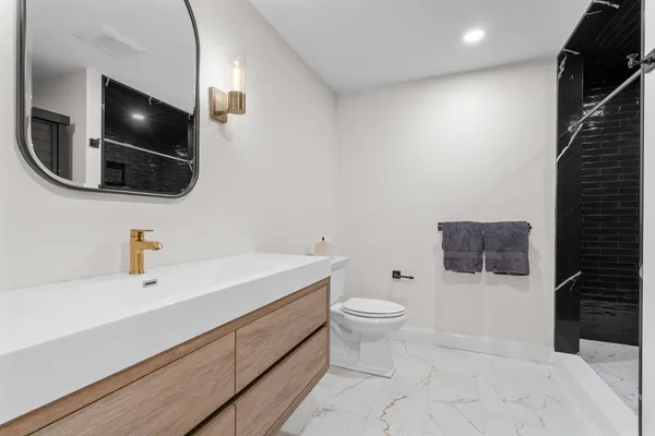 a bathroom with a toilet and a shower