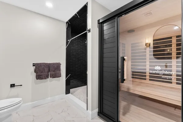 a spacious bedroom with a bed and a chandelier