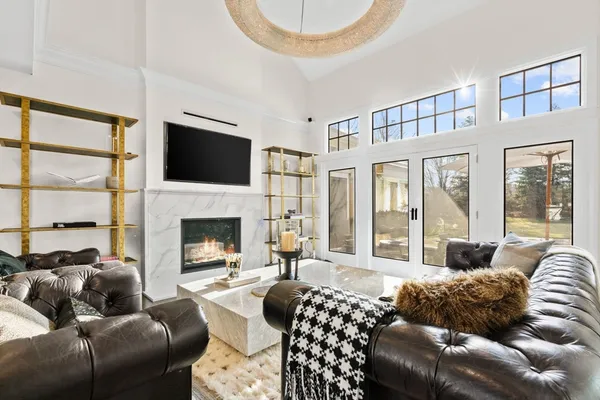 a living room with furniture a fireplace and a flat screen tv