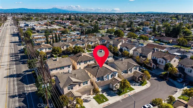 an aerial view of a houses with a city street