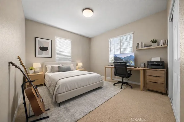 a bedroom with a bed and a desk