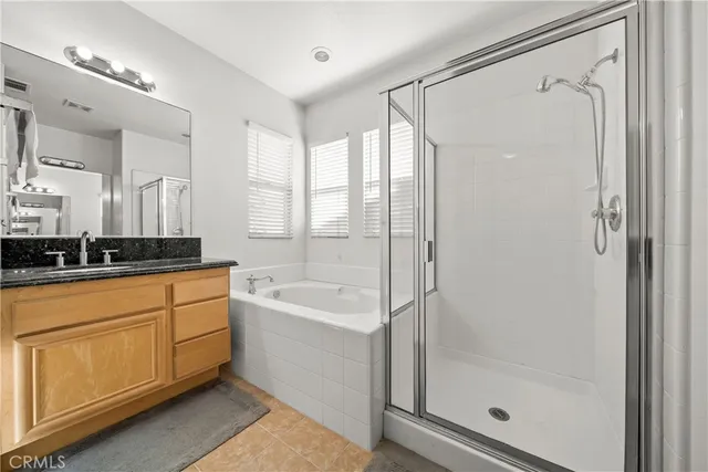 a bathroom with a tub sink shower and mirror