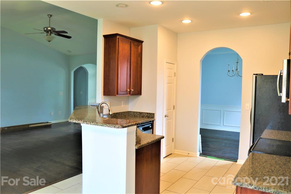 3234 Queensland Court Indian Land, SC 29707 - Photo 12 of 35 a bathroom with a granite countertop sink a mirror and a shower