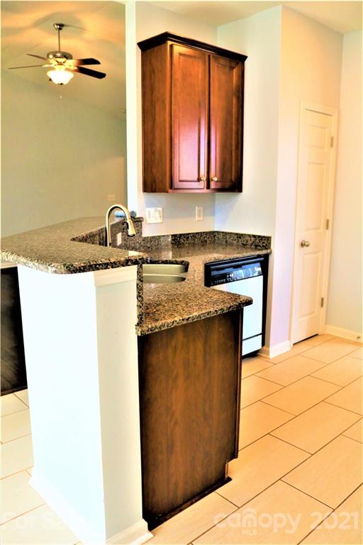 3234 Queensland Court Indian Land, SC 29707 - Photo 13 of 35 a kitchen with stainless steel appliances granite countertop a sink stove and cabinets