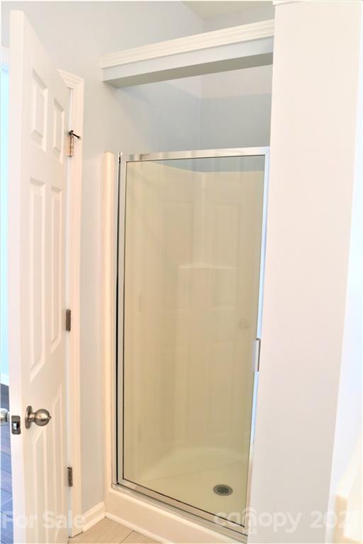 3234 Queensland Court Indian Land, SC 29707 - Photo 23 of 35 a bathroom with a glass shower door