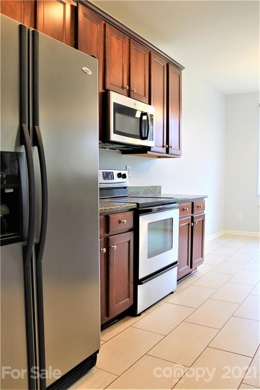 3234 Queensland Court Indian Land, SC 29707 - Photo 7 of 35 a kitchen with stainless steel appliances a stove microwave and sink