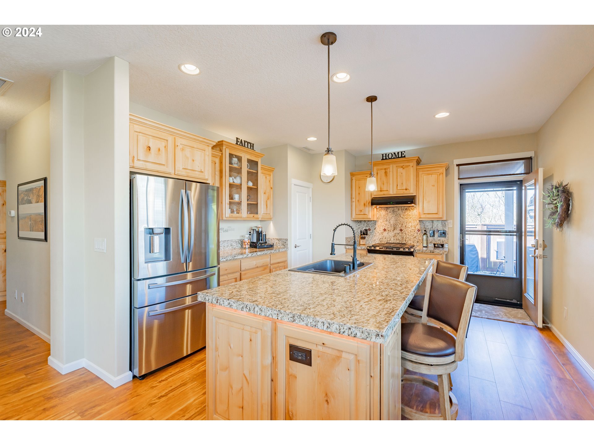 331 North 35th Avenue Ridgefield, WA 98642 - Photo 11 of 39 a kitchen with stainless steel appliances granite countertop a kitchen island a stove a refrigerator a sink a dining table and chairs