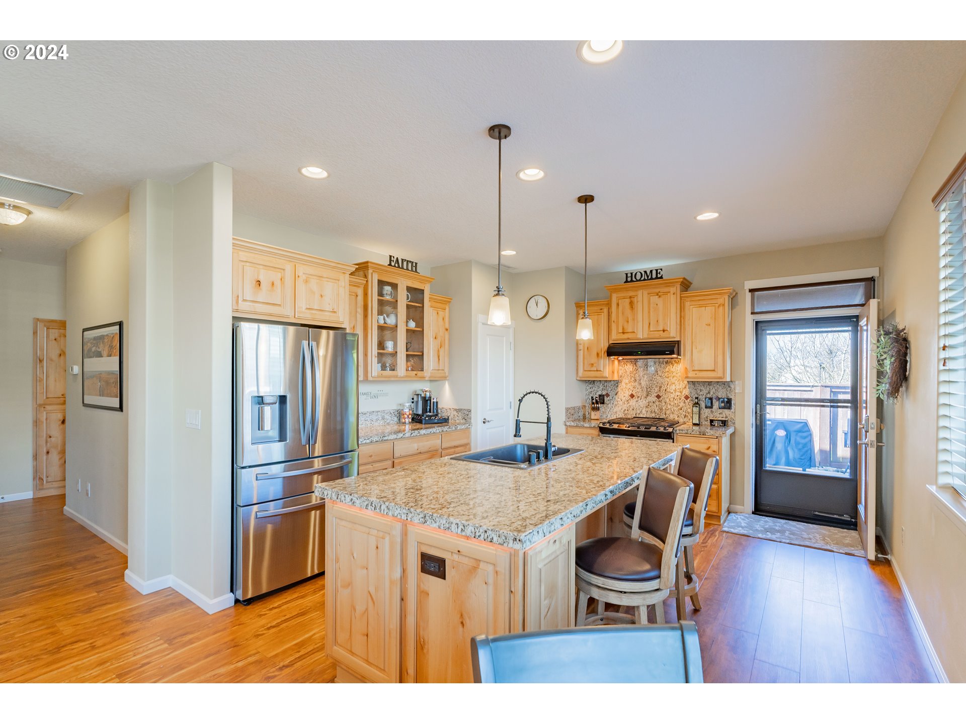 331 North 35th Avenue Ridgefield, WA 98642 - Photo 16 of 39 a kitchen with kitchen island a counter top space a sink appliances and cabinets
