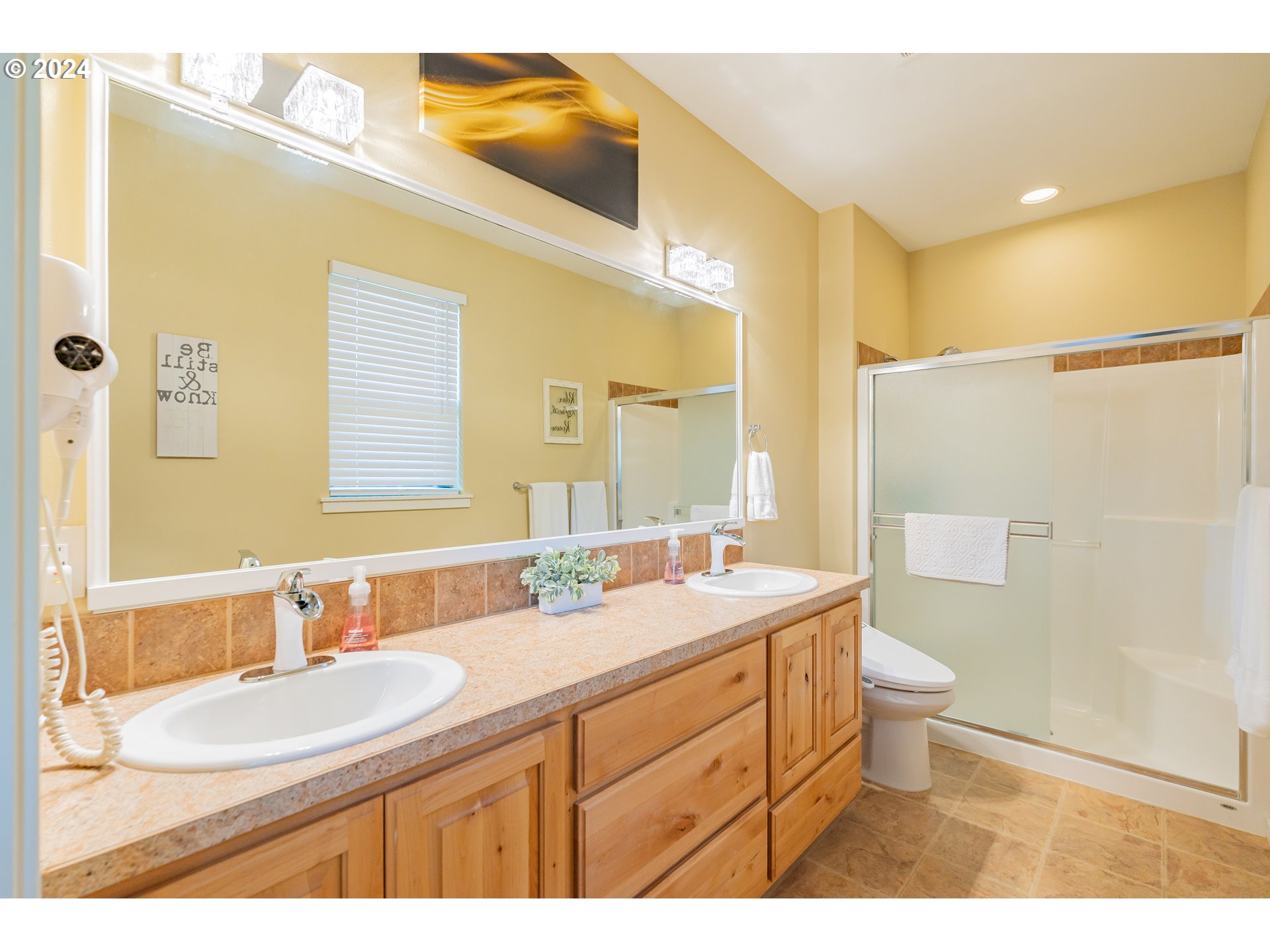 331 North 35th Avenue Ridgefield, WA 98642 - Photo 20 of 39 a bathroom with a double vanity sink toilet mirror and shower