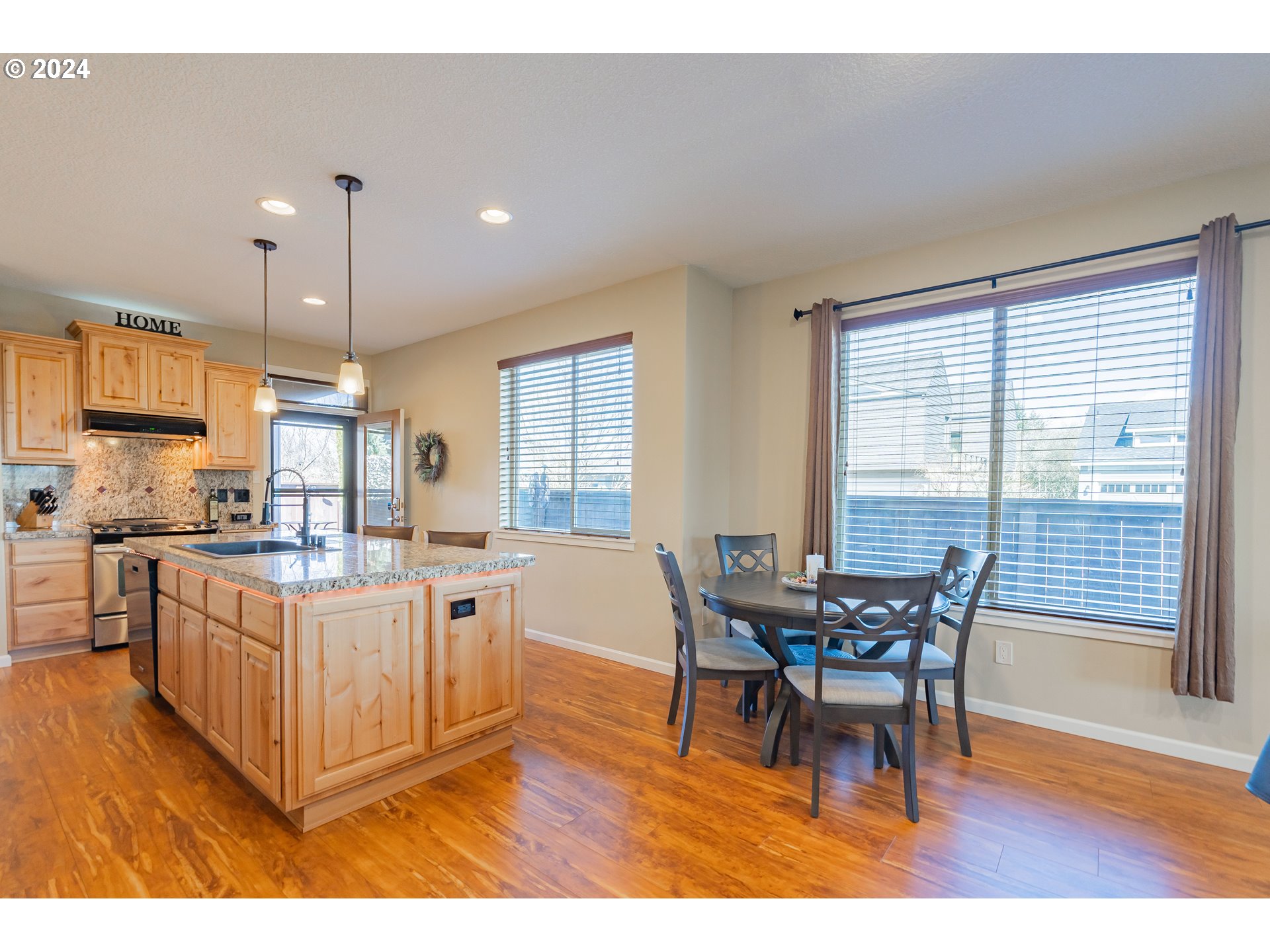 331 North 35th Avenue Ridgefield, WA 98642 - Photo 10 of 39 a kitchen with stainless steel appliances granite countertop a table chairs sink and window