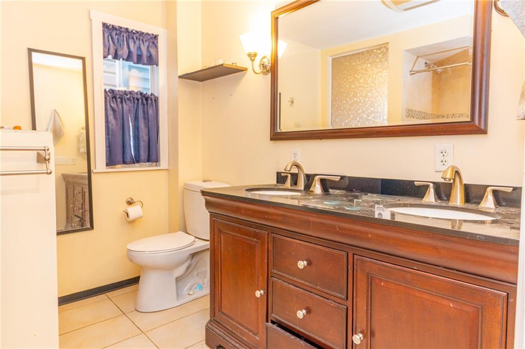70 South 11th Street Pittsburgh, PA 15203 - Photo 17 of 31 a bathroom with a toilet sink and mirror