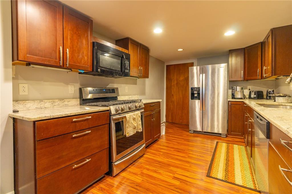 70 South 11th Street Pittsburgh, PA 15203 - Photo 8 of 31 a kitchen with stainless steel appliances granite countertop a stove a sink and a refrigerator