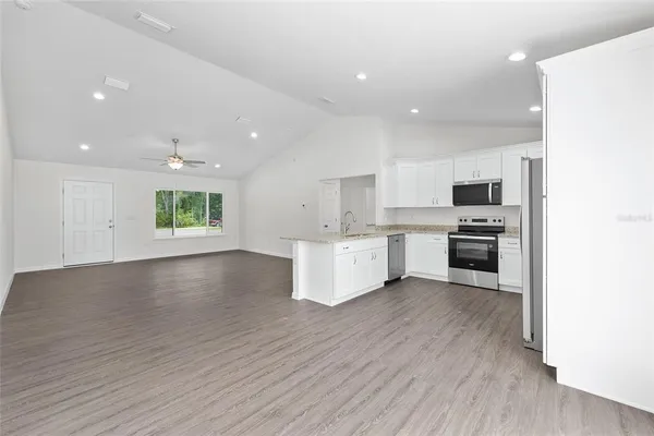 a view of kitchen with granite countertop cabinets and wooden floor