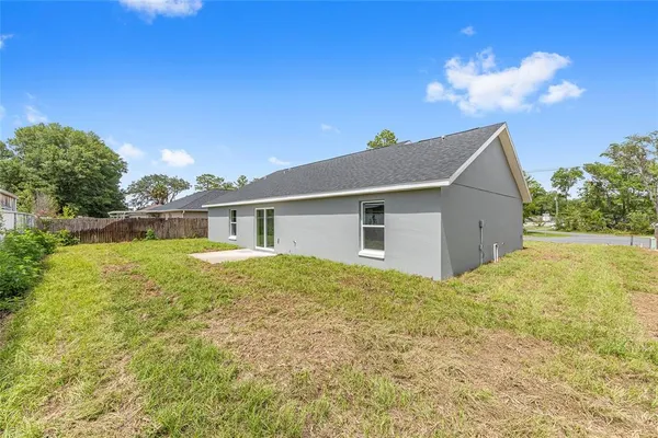 a view of backyard of house and yard with green space