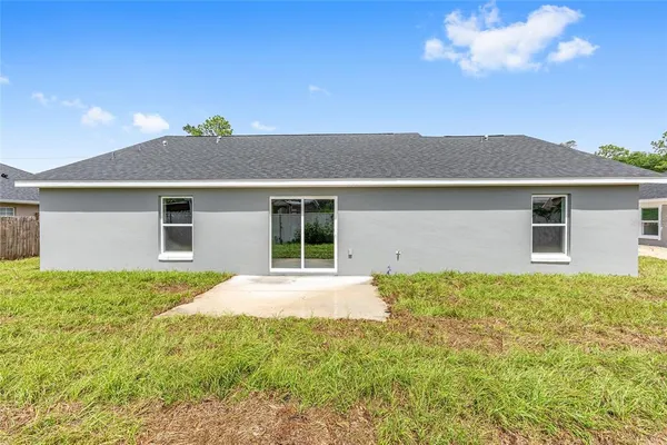 a view of a house with a backyard