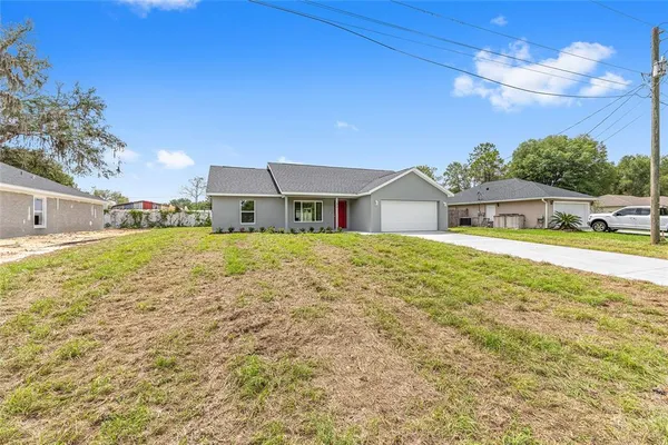 a house view with swimming pool and yard