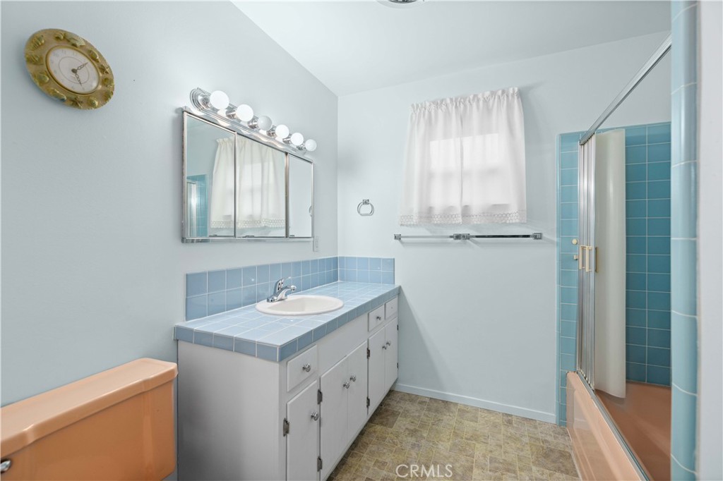 5011 East Ave R 12 Palmdale, CA 93552 - Photo 11 of 25 a bathroom with a sink a vanity and a mirror