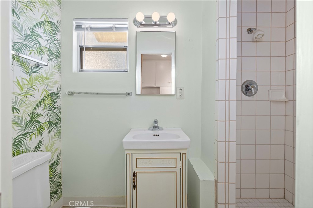 5011 East Ave R 12 Palmdale, CA 93552 - Photo 12 of 25 a bathroom with a sink a toilet and shower