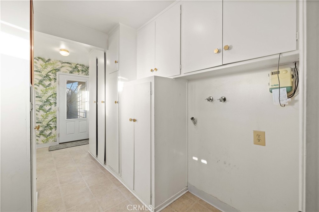 5011 East Ave R 12 Palmdale, CA 93552 - Photo 13 of 25 a view of a hallway with wooden shelves