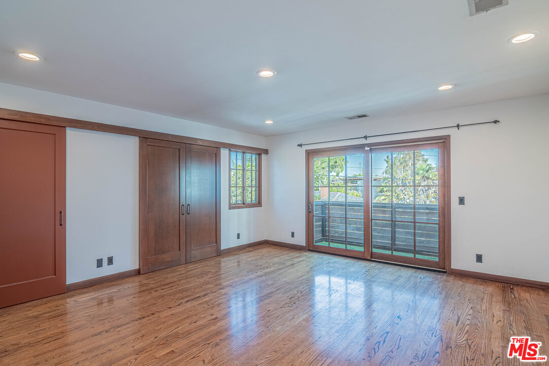 2504 Ocean Avenue Venice, CA 90291 - Photo 17 of 26 a view of an empty room with wooden floor and a window