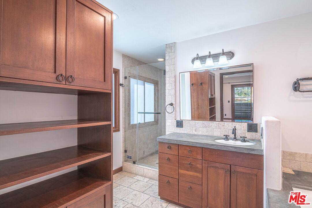 2504 Ocean Avenue Venice, CA 90291 - Photo 19 of 26 a bathroom with a granite countertop sink and a mirror