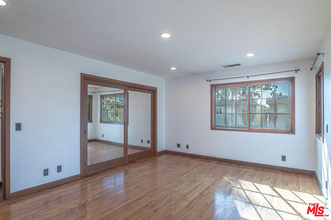2504 Ocean Avenue Venice, CA 90291 - Photo 21 of 26 a view of an empty room with wooden floor and a window
