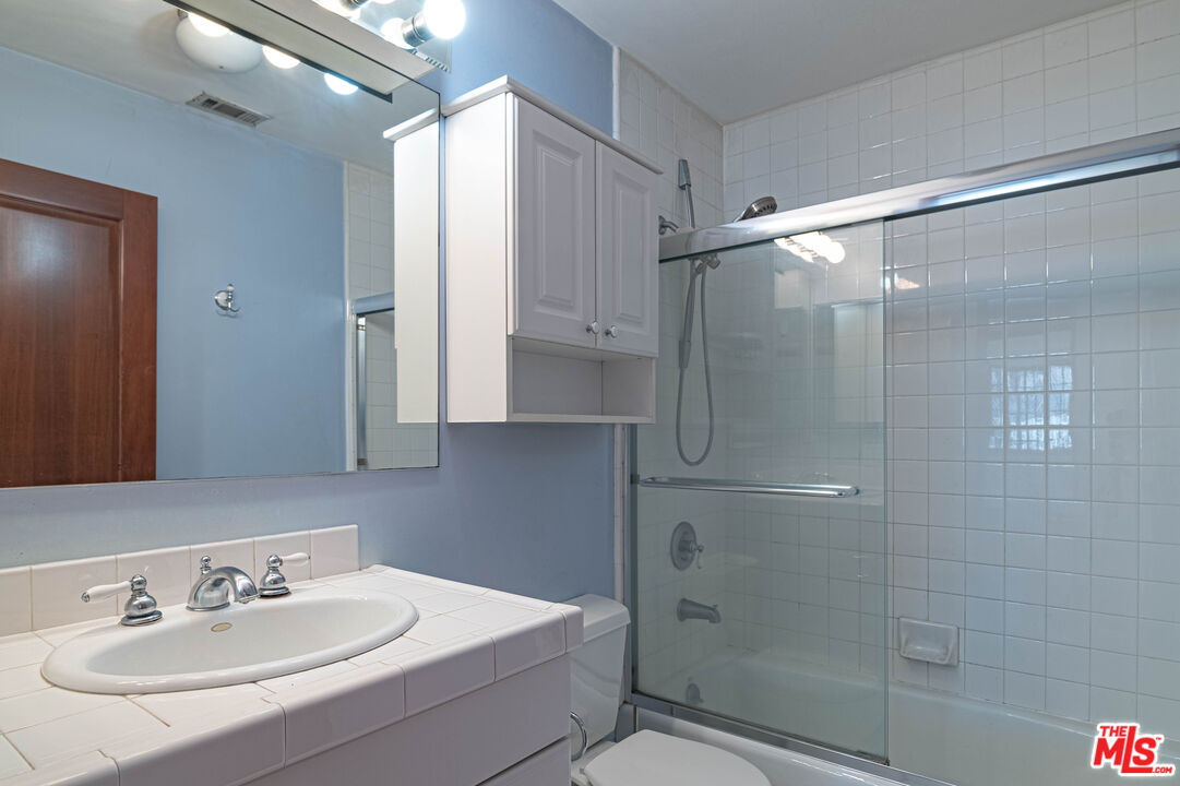 2504 Ocean Avenue Venice, CA 90291 - Photo 22 of 26 a bathroom with a sink shower and a mirror