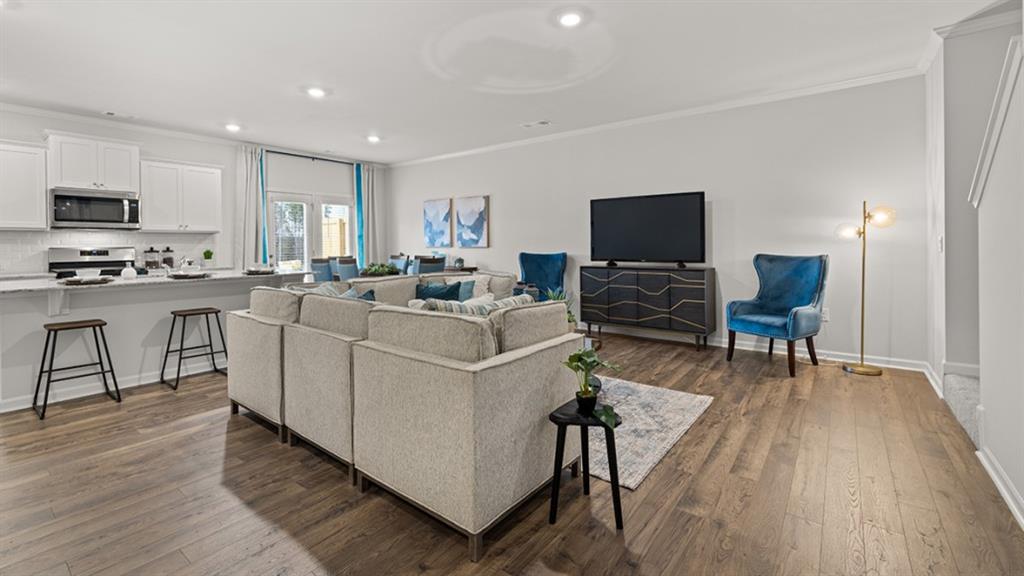3269 Ryker Road Gainesville, GA 30507 - Photo 12 of 67 a living room with furniture a flat screen tv and a wooden floor