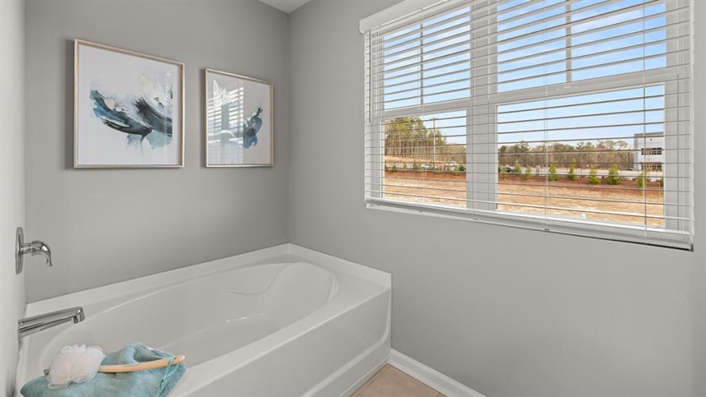 3269 Ryker Road Gainesville, GA 30507 - Photo 26 of 67 a bathroom with a bathtub and a window
