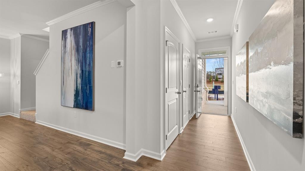 3269 Ryker Road Gainesville, GA 30507 - Photo 3 of 67 a view of a hallway with wooden floor and a bathroom