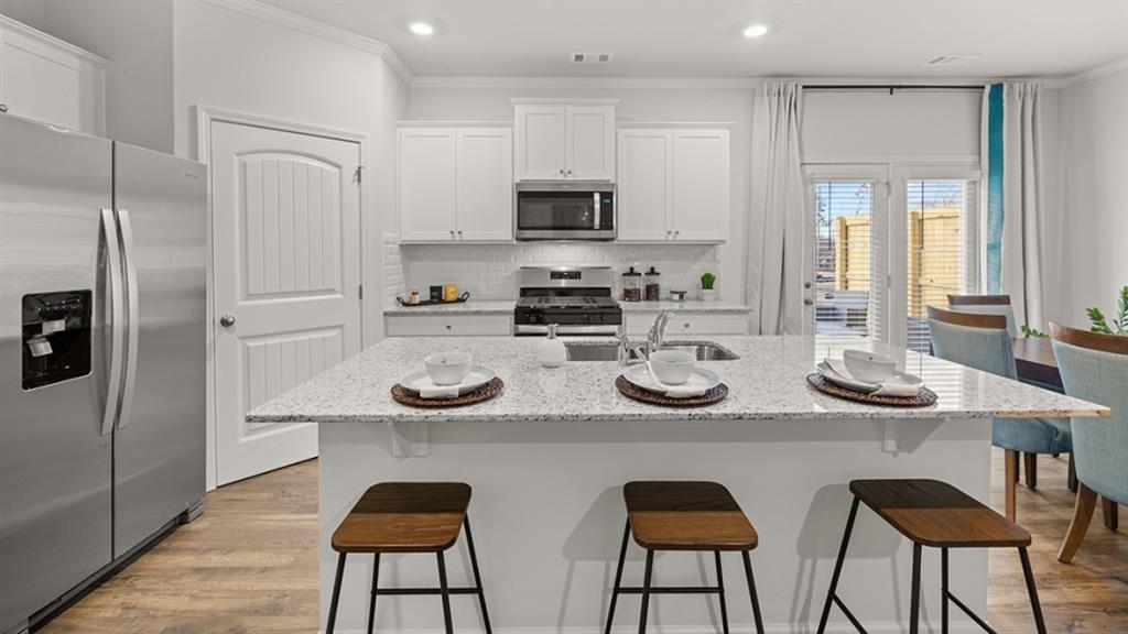 3269 Ryker Road Gainesville, GA 30507 - Photo 4 of 67 a kitchen with stainless steel appliances kitchen island granite countertop a table and chairs in it
