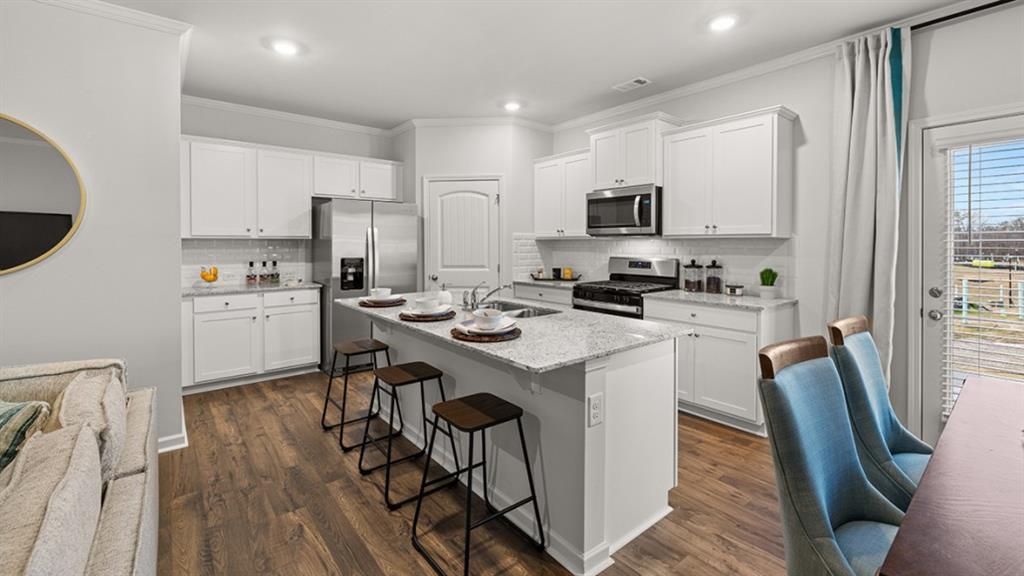 3269 Ryker Road Gainesville, GA 30507 - Photo 5 of 67 a kitchen with stainless steel appliances a stove a sink dishwasher a refrigerator with white cabinets and wooden floor