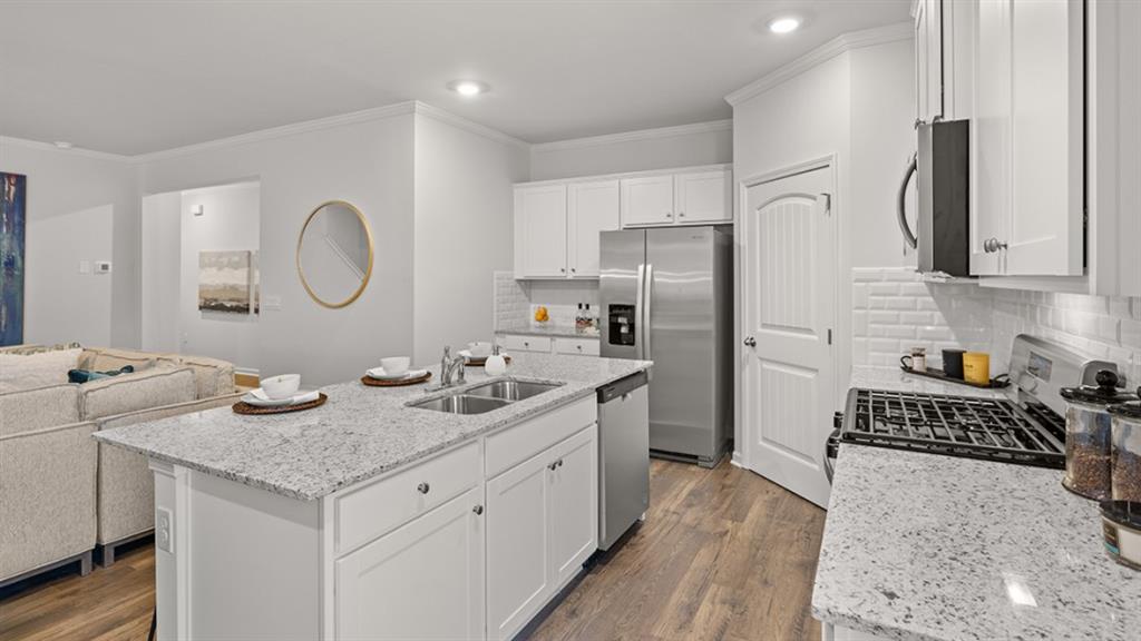 3269 Ryker Road Gainesville, GA 30507 - Photo 8 of 67 a kitchen with stainless steel appliances granite countertop a sink stove refrigerator and cabinets