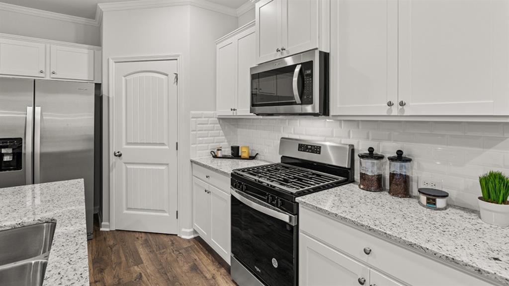 3269 Ryker Road Gainesville, GA 30507 - Photo 9 of 67 a kitchen with granite countertop a sink stove and refrigerator