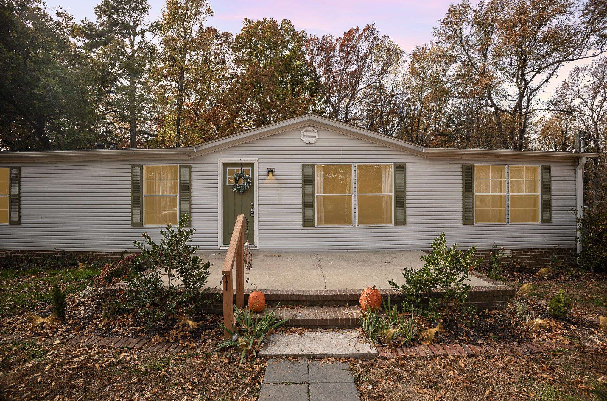100 Barnette Tingen Road Roxboro, NC 27574 - Photo 26 of 27 a front view of a house with a garden