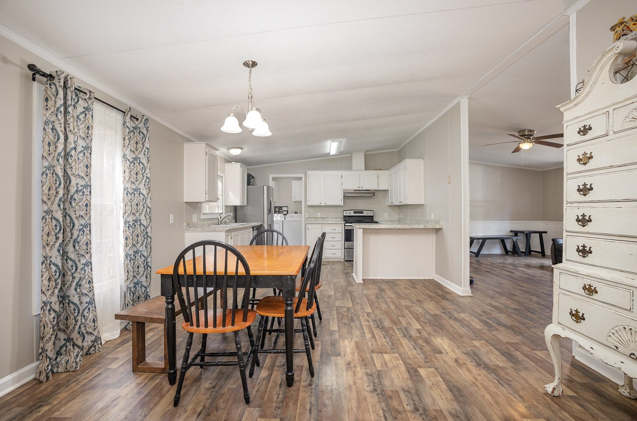 100 Barnette Tingen Road Roxboro, NC 27574 - Photo 6 of 27 a kitchen with stainless steel appliances kitchen island granite countertop a table chairs sink and cabinets