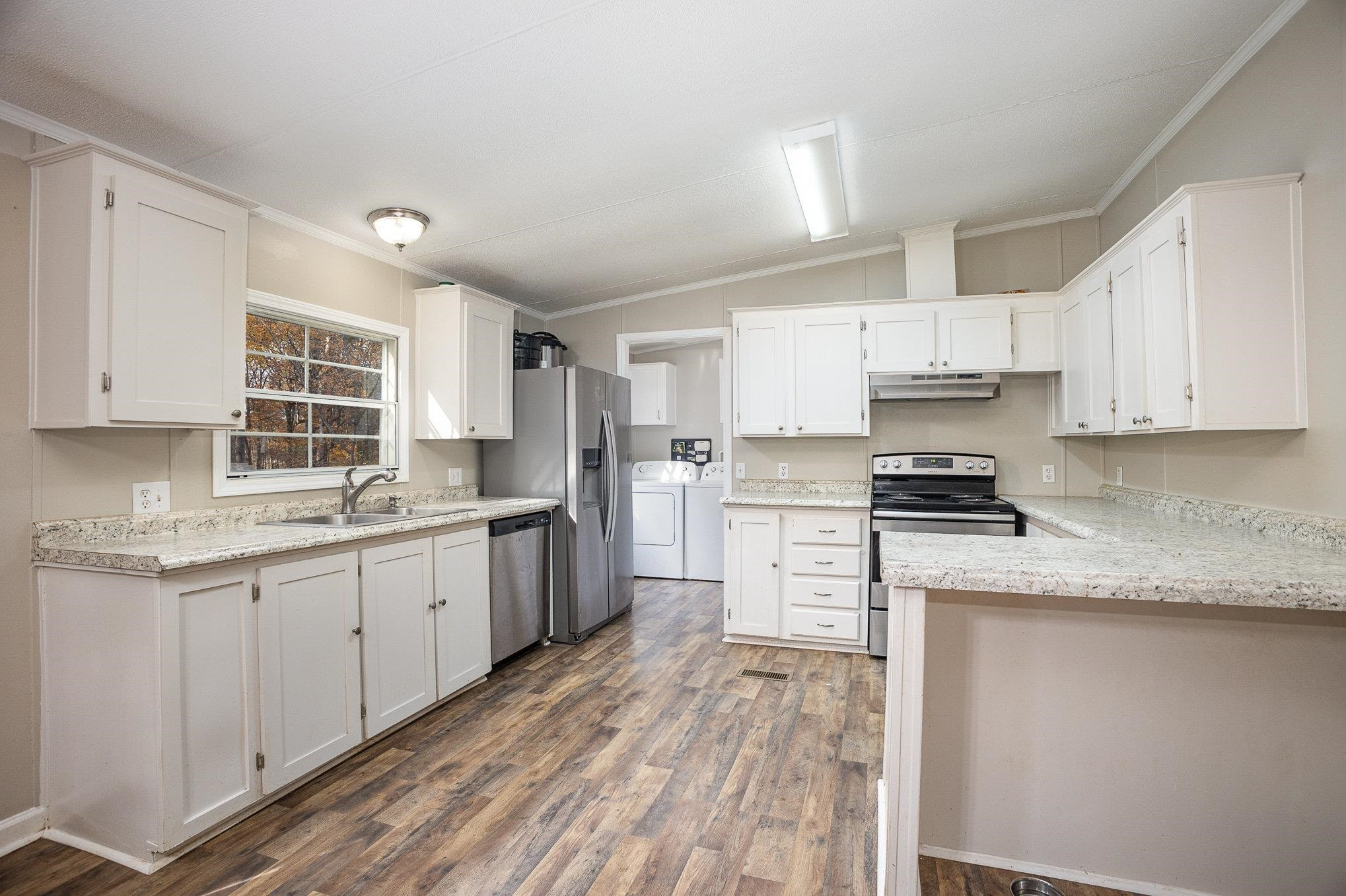 100 Barnette Tingen Road Roxboro, NC 27574 - Photo 7 of 27 a kitchen with granite countertop white cabinets and white appliances