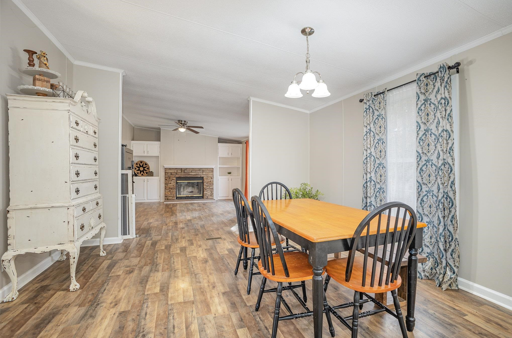 100 Barnette Tingen Road Roxboro, NC 27574 - Photo 10 of 27 a view of a dining room with furniture and wooden floor