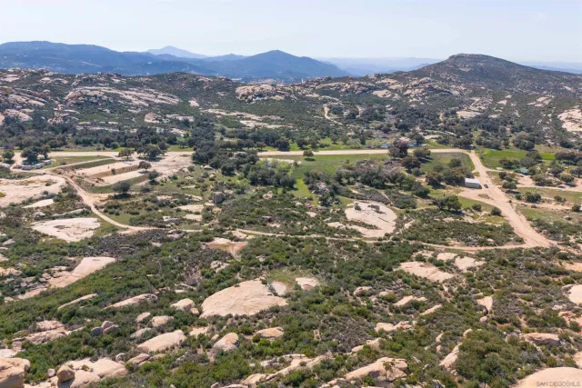 a large kitchen with stainless steel appliances granite countertop a refrigerator and a stove top oven