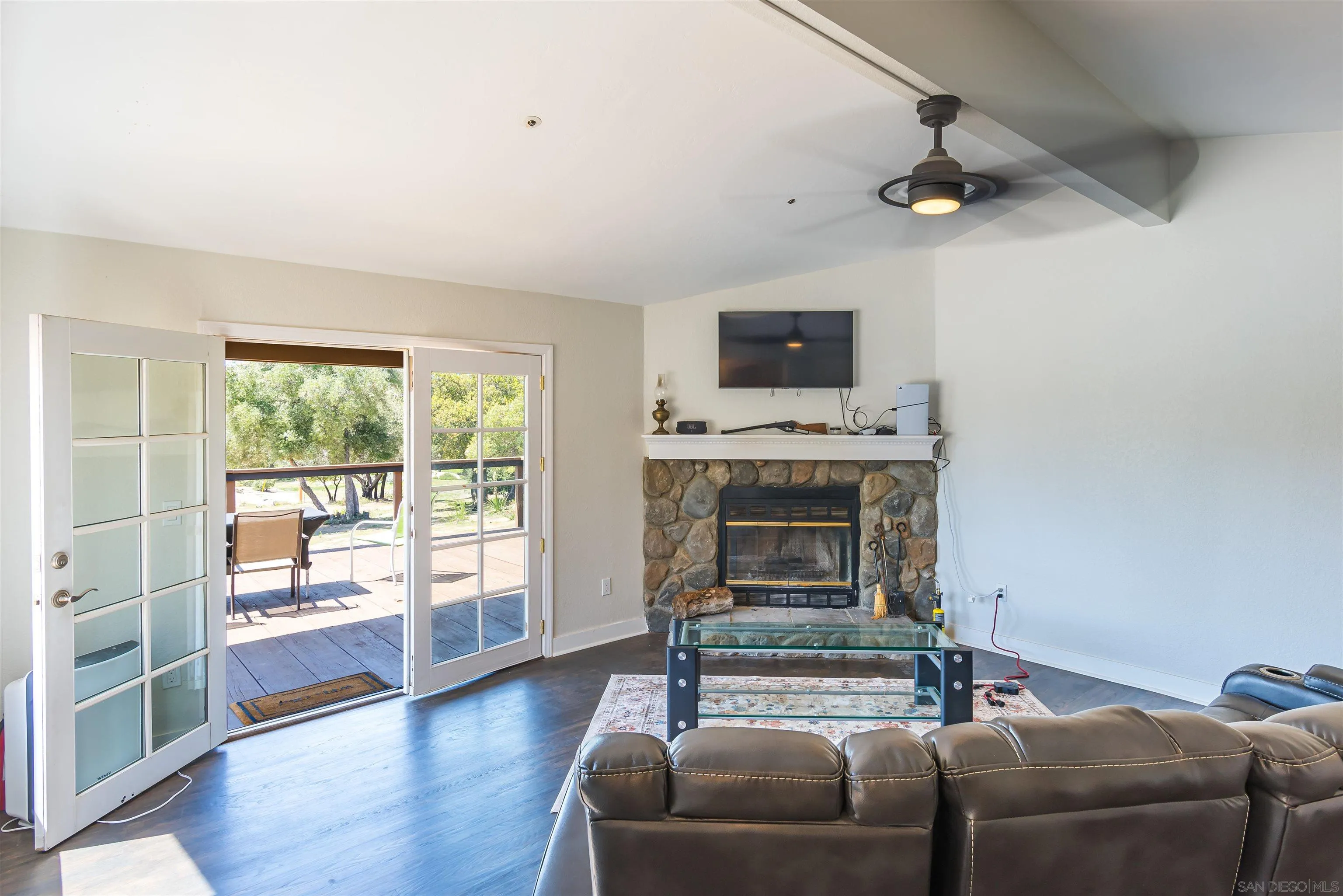 0 High Glen Road Alpine, CA 91901 - Photo 37 of 74 a living room with furniture a flat screen tv and a fireplace