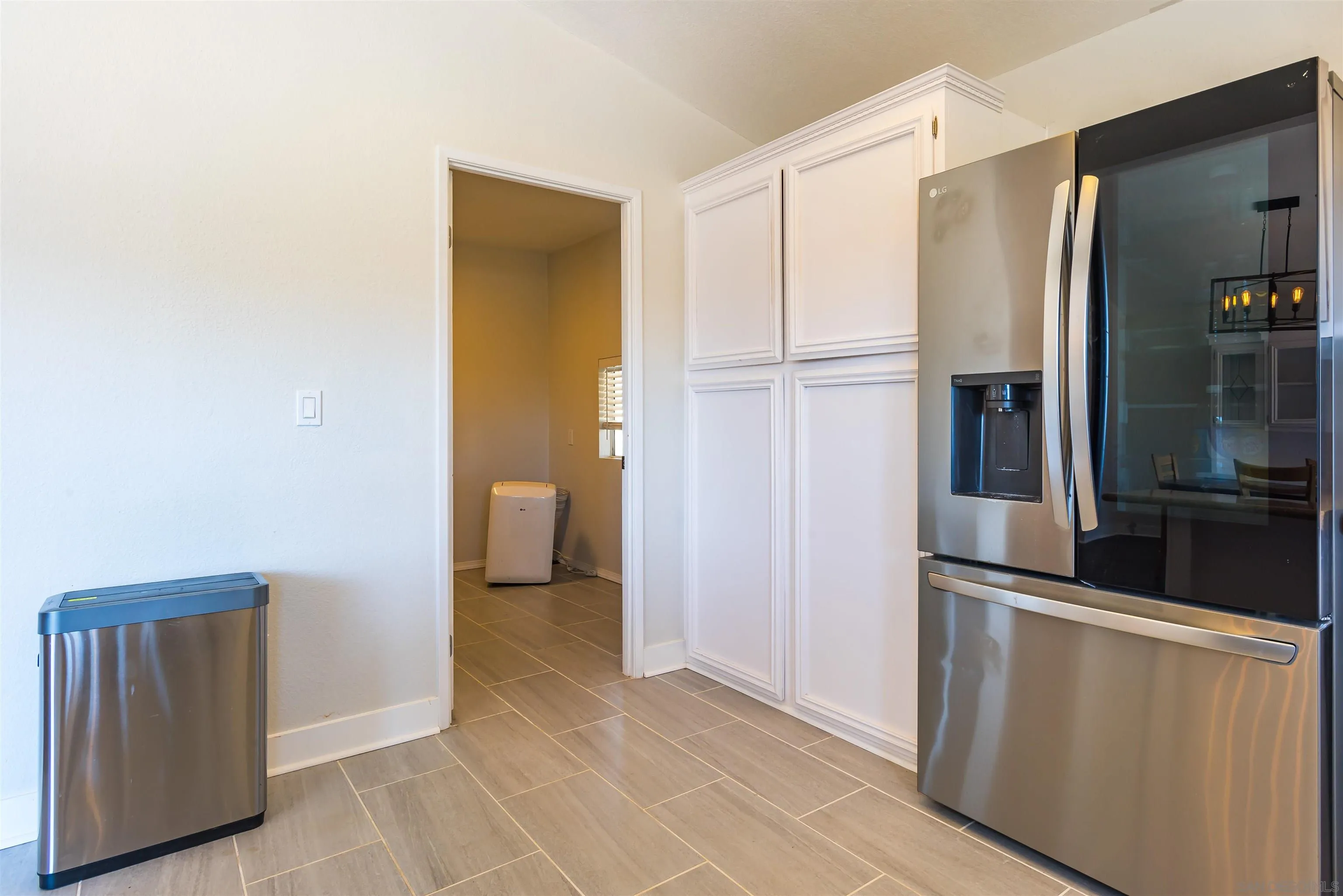 0 High Glen Road Alpine, CA 91901 - Photo 44 of 74 a view of a refrigerator in kitchen and an empty room with wooden floor