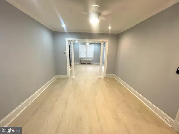 en empty room with wooden floor and sliding door