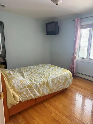 a bed sitting in a bedroom next to a window