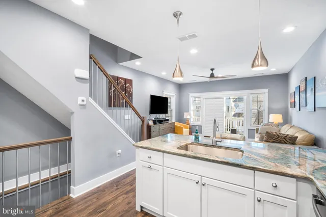 a hallway with sink and mirror